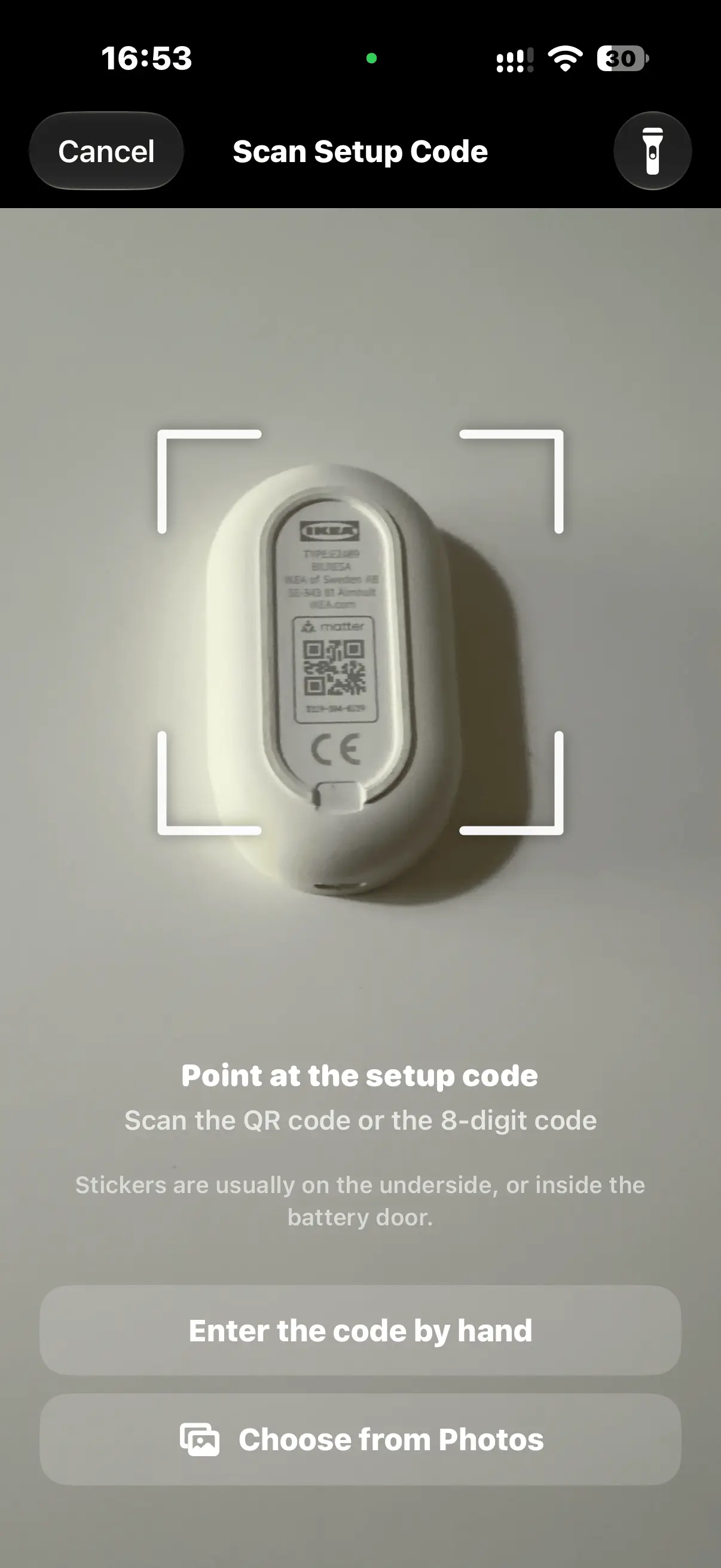 The setup code scanner framing the Matter QR code on the back of an IKEA switch, with options to enter the code by hand or choose it from Photos.